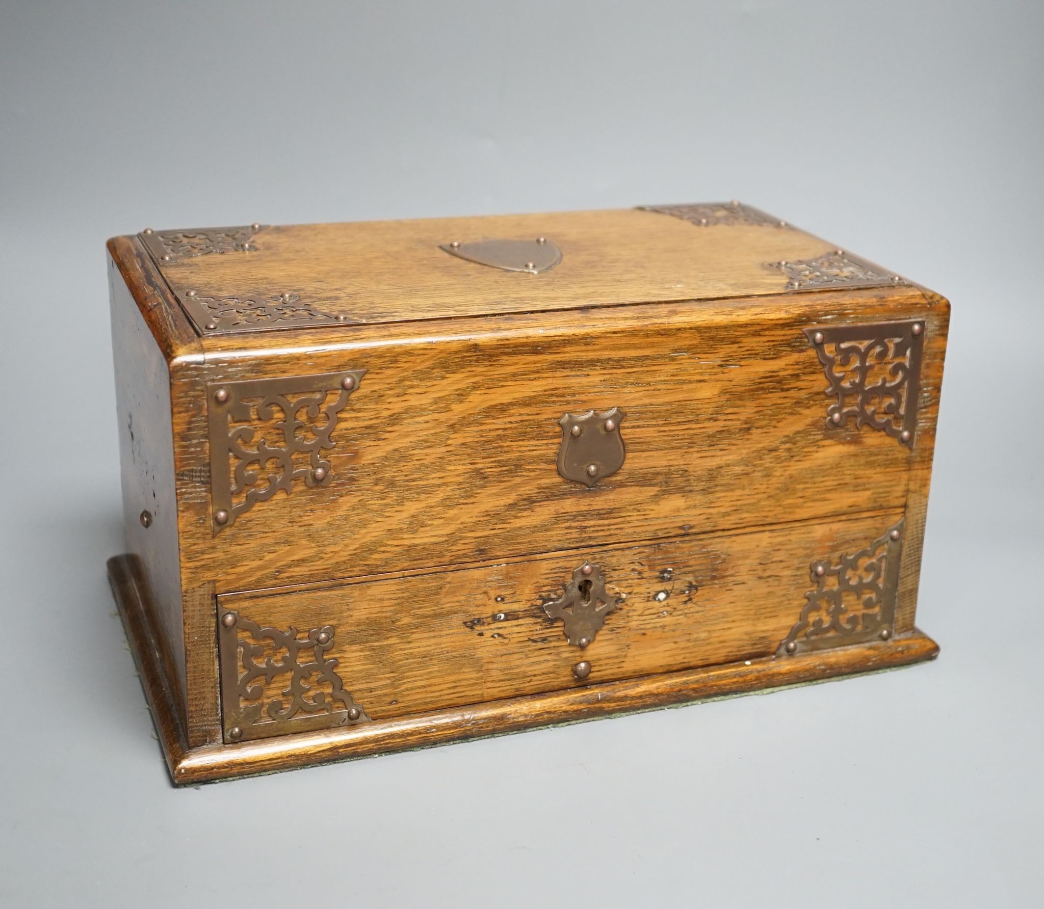 A Victorian oak smoker's box, with brass mounting, 30 cms wide x 17 cms high.